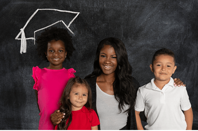 global-refuge-services-kids-and-teacher-in-front-of-blackboard