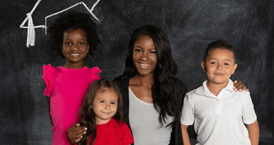 global-refuge-services-kids-and-teacher-in-front-of-blackboard